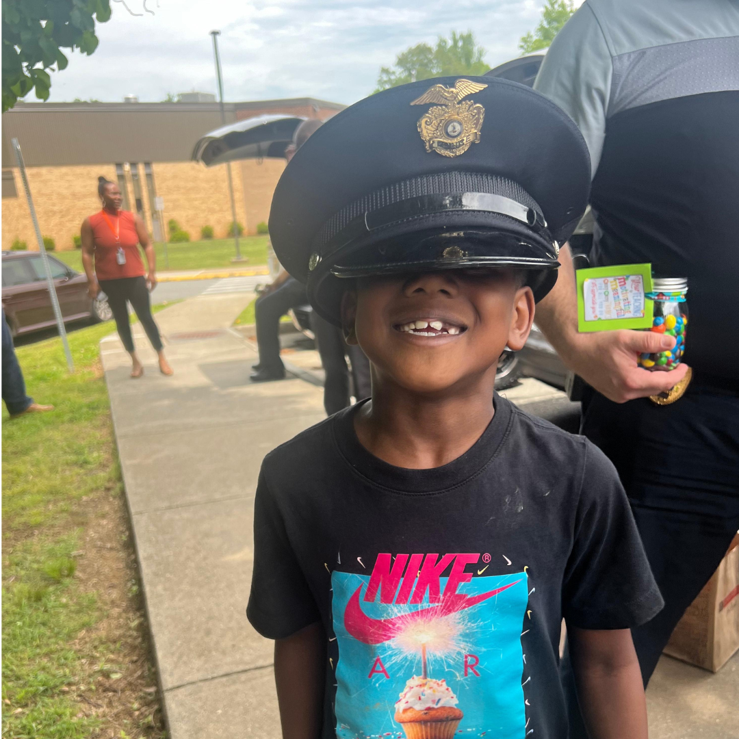 student wears police hat